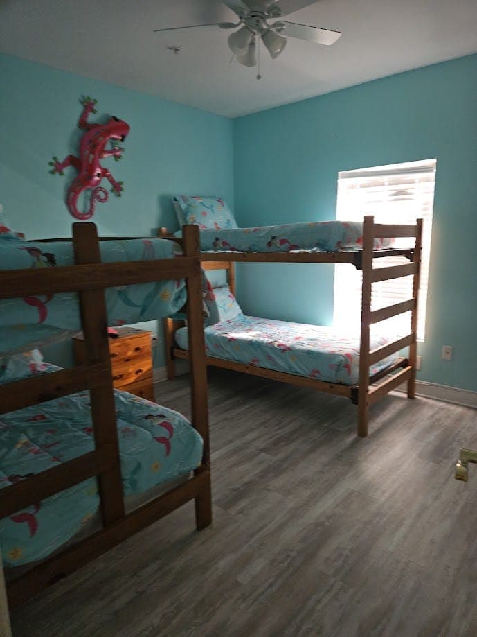 Bedroom with bunk beds and mermaid-themed bedding in a vacation rental